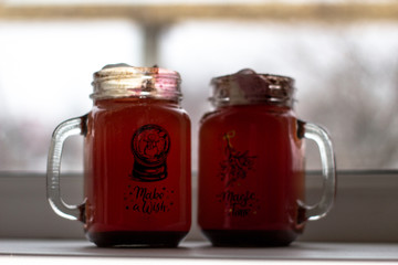 Mugs with chocolate and  ginger cookies on a wood desk with different lights