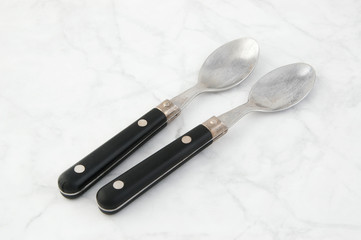 Spoons on white gray background.