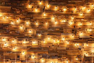 Modern dark classical style interior design apartment with retro lamps hanging light bulbs background. Wooden planks with lamps. Decorated interior room with gold lights. Copy space mockup poster