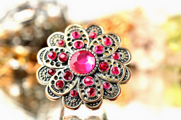 Brooch - richly decorated, red artificial stones - close-up