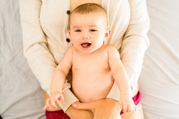 Newborn baby girl posed and playing with her tongue to talk, looking at camera