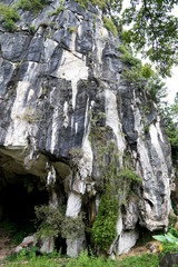 Beautiful natural limestone cave entrance in Malaysia. Limestone Hill and Cave.Jungle covered and dramatic rounded hill and huge hollow feature. - Image           