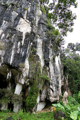 Beautiful natural limestone cave entrance in Malaysia. Limestone Hill and Cave.Jungle covered and dramatic rounded hill and huge hollow feature. - Image           