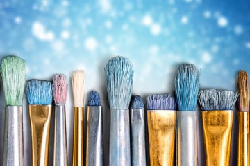 Row of artist paint brushes  on background