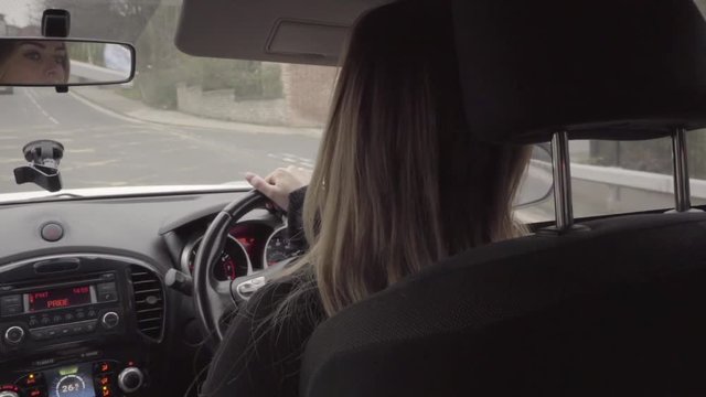 attractive woman driving car whilst talking on hands free in slow motion