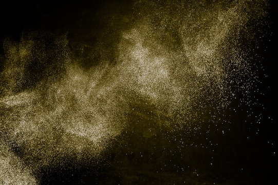 golden powder color spreading effect for makeup artist or graphic design in black background