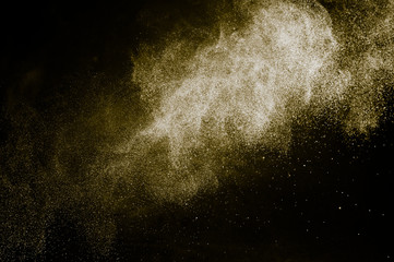 Fototapeta na wymiar golden powder color spreading effect for makeup artist or graphic design in black background