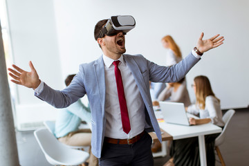Business people making team training exercise during team building seminar using VR glasses