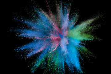 Colored powder explosion. Abstract closeup dust on backdrop. Colorful explode. Paint holi