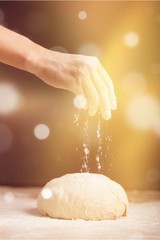 Fototapeta premium Woman's hands knead the dough close up