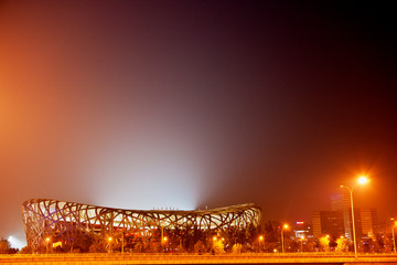 Illuminated sports stadium at night.