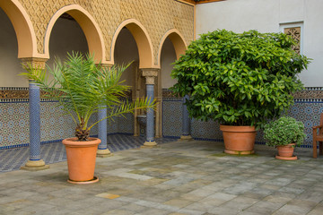 Fototapeta na wymiar Oriental style park with plants and part of turkish architecture 