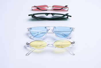 Female sunglasses on white background. Flat lay, top view.