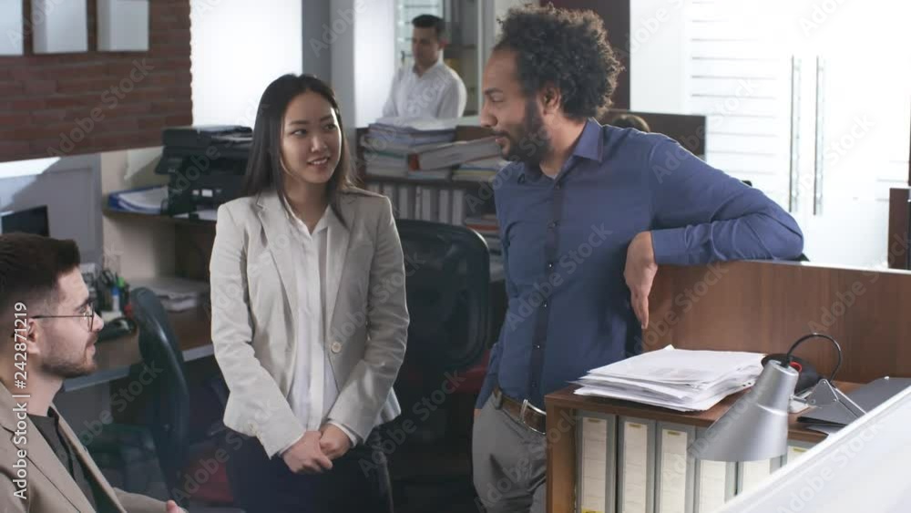 Poster group of three business colleagues of different ethnicities having conversation with each other duri