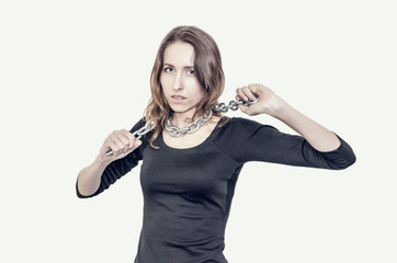 Slim figure girl in black dress. Metal chain around the neck. Slavery, exploitation of people, lack...