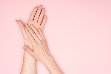 cropped view of female hands isolated on pink with copy space