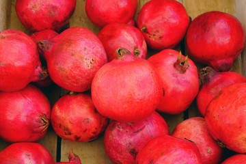 Crate of fresh red pomegranate fruit