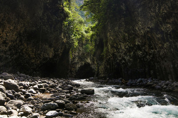 Cliffs looming over the creek and further cave