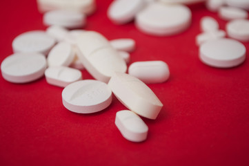 closeup of white pils on red  background