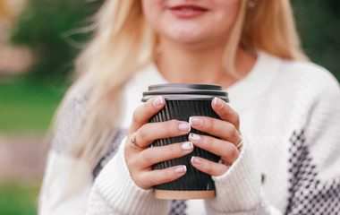 woman holding coffee, closeup