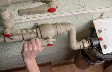 Plumber closes  water supply pipeline. Close-up.