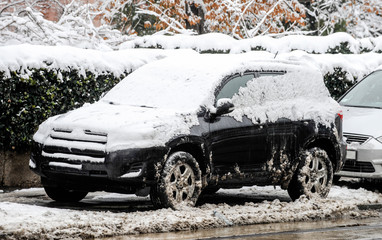 A car covered with snow parked on the street