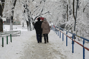 A couple walking down the street in winter