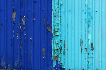 two-tone background.peeling paint on a shipping container.