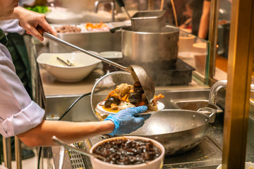 Chef cooking clams, mussel, cockle in the hotel kitchen