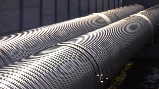The isolated pipes in a cover from polyethylene of low pressure in a cover from galvanized steel. Galvanized steel sheathed pipes for above ground gaskets.