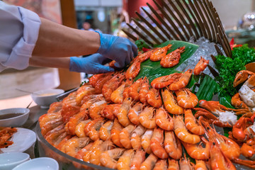 Waiterhand put cooked shrimps into the Shrimps tower