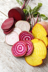 Four different types of beets. Yellow, striped chioggia, white, and ordinary maroon.