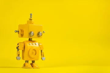 Fotobehang Robot on a yellow background. © ardasavasciogullari