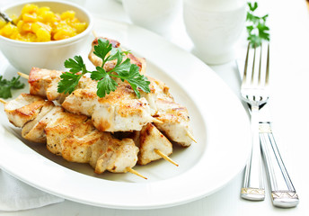 chicken skewers with apple-apricot chutney. Selective focus.