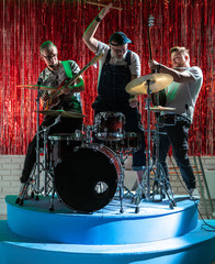 Fototapeta na wymiar Three musicians play musical instruments