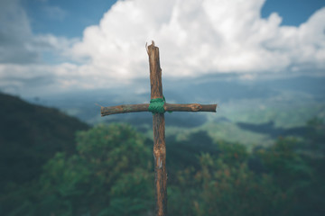 The cross with nature in the forest on the hill is the Blackground.