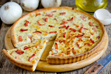 Traditional german onion cake zwiebelkuchen, onion pie with ham on thin dough