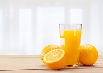 Orange juice and slices of orange on background