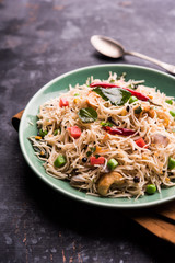 Semiya Upma or Vermicelli Uppuma or uppittu is a popular breakfast menu from south India. served in a bowl. selective focus