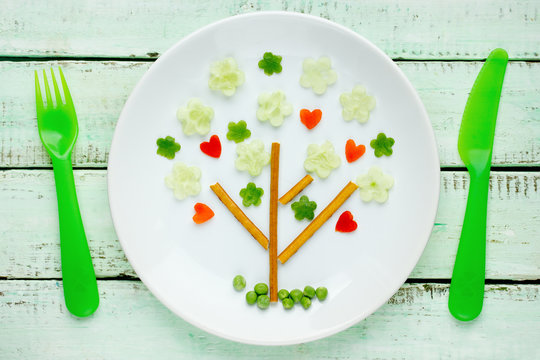 Fun food, vegetables snack plate shaped green tree, springtime and love theme food art