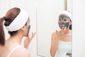 beautiful woman masking her face on white background