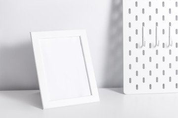Photo frame on white table