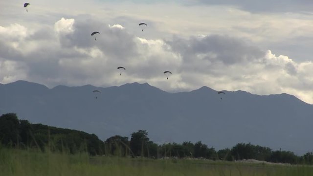 Panoramic view of group of people doing parachuting