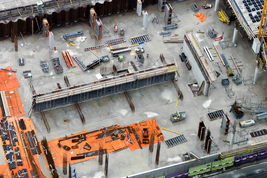 Top View Of A Busy Construction Site With Various Equipment.