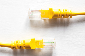 yellow network internet cable on a white background close-up
