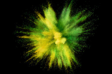 Colored powder explosion. Abstract closeup dust on backdrop. Colorful explode. Paint holi