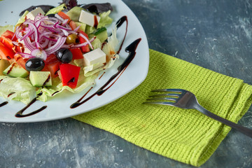 Greek salad with fresh vegetables, feta cheese and black olives