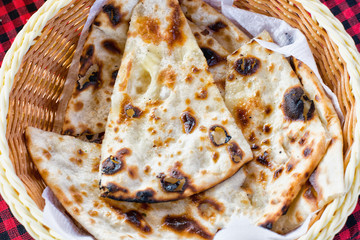 tortillas in a plate on a checkered tablecloth