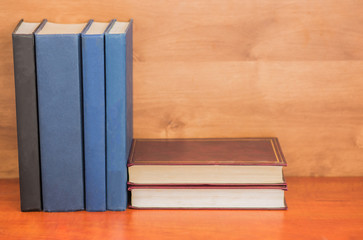 Pile of closed books on  wooden background