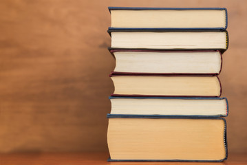 Pile of closed books on  wooden background